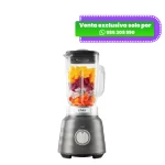 Licuadora Osterizer Max gris con vaso de vidrio lleno de frutas picadas.